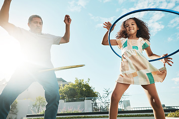 Image showing Grandfather, girl child and family hula hoop in city, having fun and bonding together outdoors. Love, portrait and low angle of grandpa and kid playing with hoops toy, dance and enjoying quality time