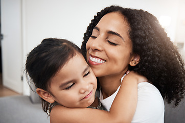 Image showing Hug, love and girl with mother on a sofa, happy and smile while hugging in their home together. Family, embrace and parent with child on a couch, bond and cheerful, loving and caring in a living room