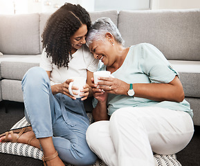 Image showing Relax, laughing and senior mother and daughter with coffee cup for home conversation, talking and bonding together. Black family, people or woman with elderly mom love, tea and living room carpet