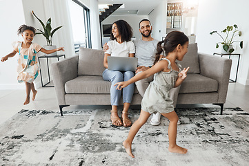 Image showing Black family home, kids and running in living room for game, bonding or funny time with parents on sofa. Children, mother and father on lounge couch with laptop, smile and happiness for love together