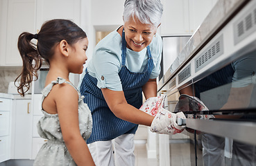 Image showing Learning, cooking and grandmother with girl by oven in kitchen baking delicious meal. Education, development and happy grandma teaching kid how to bake, bonding and enjoying quality time together.