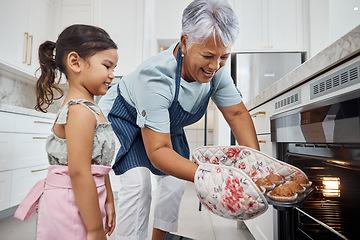 Image showing Muffins, learning and grandmother with girl cooking and taking out cupcakes from oven. Education, kitchen and happy grandma teaching child how to bake, bonding and enjoying quality time together.