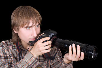 Image showing Young  photographer with the camera with a zoom lens