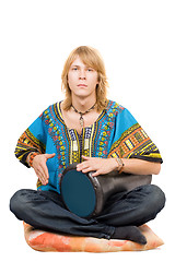 Image showing The young man plays a drum. Isolated 