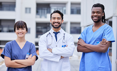 Image showing Portrait, healthcare or collaboration with a doctor and team standing arms crossed outside of a hospital. Medical, teamwork or trust with a man and woman professional medicine group feeling confident