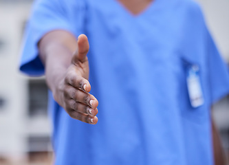 Image showing Doctor, handshake or black woman medical worker greeting, welcome or shaking hands in hospital, office or clinic. Trust, partnership or nurse for support, help or onboarding team deal and thank you.