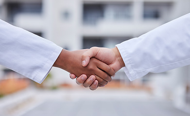 Image showing Handshake, b2b meeting and doctors shaking hands for success collaboration, teamwork and medicine partnership. Thank you, welcome and medical support from startup company employee at hospital lobby