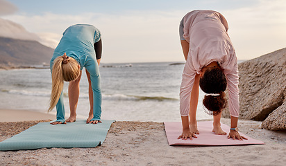 Image showing Pilates, fitness and woman friends on the beach together for mental health, wellness or balance in summer. Exercise, diversity or nature with a female yogi and friend practicing yoga outside