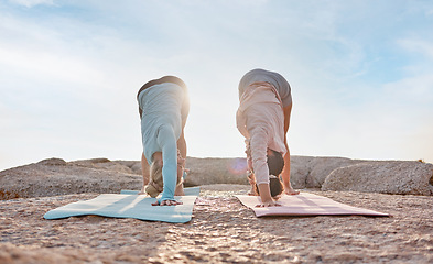 Image showing Yoga, exercise and woman friends on the beach together for mental health, wellness or balance in summer. Exercise, diversity or nature with a female yogi and friend outside for health or mindfulness