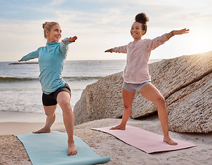 Image showing Yoga, fitness and woman friends stretching on the beach together for mental health or wellness in summer. Exercise, diversity or nature with a female yogi and friend practicing meditation outside