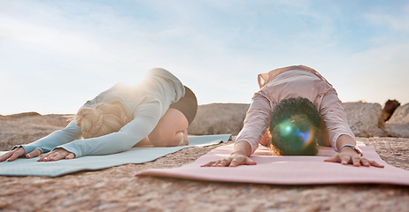 Image showing Yoga, women or child pose on rock mat in workout, training or bonding exercise for back pain. Relax, stretching or yogi friends in beach, nature pilates or fitness flexibility for healthcare wellness