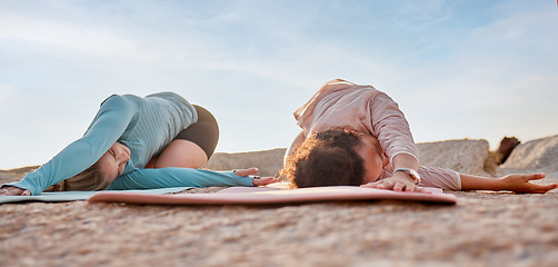 Image showing Yoga, women or stretching on beach mat in workout, training or bonding exercise twist for back pain. Child pose, relax or yogi friends in nature pilates or fitness flexibility for healthcare wellness