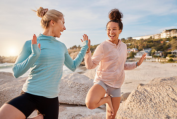 Image showing Women friends, yoga and ocean in morning with stretching pose for health, zen wellness or high five for support. Black woman, exercise group and comic laugh for balance, peace and solidarity at beach