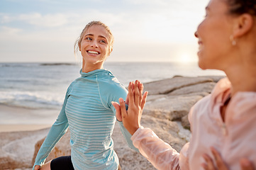 Image showing Fitness, touching hands and couple of friends at the beach for workout, training or exercise together for support. High five with love of diversity woman or lesbian people for cardio care by ocean