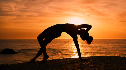 Image showing Balance, yoga and silhouette of woman on beach at sunrise for exercise, training and pilates workout. Fitness, meditation and shadow of girl by ocean for sports, wellness and stretching in morning