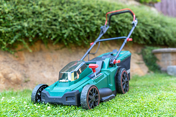 Image showing battery electric lawn mowers in the garden