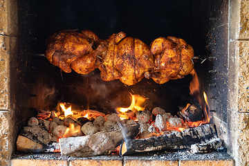 Image showing chicken roasting on a spit