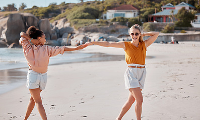 Image showing Couple holding hands on beach, lesbian and fun by ocean, gay women outdoor with adventure and freedom to love. Interracial, laugh and holiday in Australia, lgbtq with travel and happy dance together