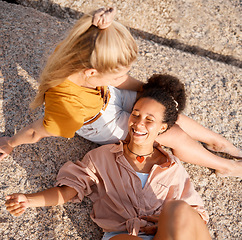 Image showing Above, friends and relax at the beach for summer, vacation and bonding while lying on the ground together, happy and laugh. Smile, travel and women on floor with peace, freedom and chilling outdoors