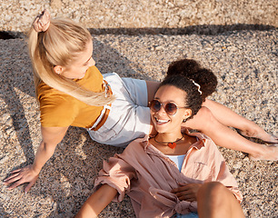 Image showing Friends, above and relax at the beach for summer, vacation and bonding while lying on the ground together, happy and laugh. Smile, travel and women on floor with peace, freedom and chilling outdoors