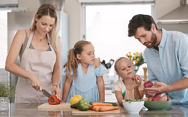 Image showing Mom, dad and children cooking with vegetables ingredients for lunch, dinner or meal prep. Family, food and parents with girls learn, development and help in kitchen for nutrition, diet and wellness