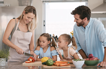 Image showing Mom, dad and children cooking in kitchen with vegetables for nutrition, healthy lunch and vegan diet. Family, food and parents with girls learning, teaching and helping cut ingredients for meal prep