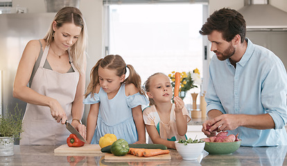 Image showing Parents, food and children cooking in kitchen with vegetables for nutrition, vegan lifestyle and healthy eating. Food, family and mom, dad and girls learning and help for meal prep, dinner or lunch