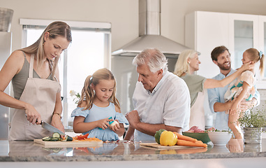 Image showing Big family, cooking and vegetables with a child helping mother and grandfather in the kitchen. Woman, man and girl kid learning to make lunch or dinner with love, care and bonding over food together