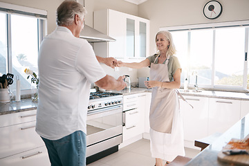 Image showing Senior couple, bonding and dancing in kitchen, house or family home in support trust, love or fun energy celebration. Smile, happy and retirement man in dance with elderly woman in romance marriage