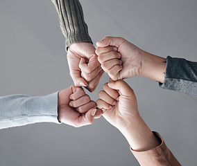 Image showing People, hands and fist bump in trust for unity, collaboration or team agreement in solidarity. Hand of support group bumping fists in teamwork, partnership or coordination for community achievement