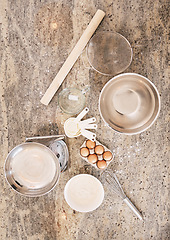 Image showing Top view, baking or ingredients on kitchen table or countertop for pastry dish, wheat cake or bread food. Above, bakery or cooking eggs and equipment for pudding, dessert or cookies in house or home