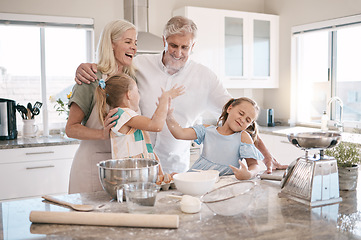 Image showing Family, baking and high five with children helping grandparents in home kitchen. Woman, man and girl kids learning to make cookies, pancakes or cake using flour with love, care and teamwork for food