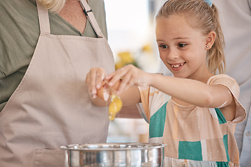 Image showing Child, girl and baking with eggs, grandparent or senior woman in kitchen, bonding house or family home for pastry, dessert cake or food. Happy smile, cooking and kid learning a bakery cookies recipe