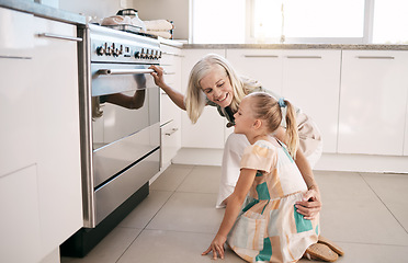 Image showing Kitchen, happy and grandmother with a kid by the oven watching the cake, cookies or pie bake. Happiness, smile and senior woman with a girl child cooking or baking for dinner, party or event at home.