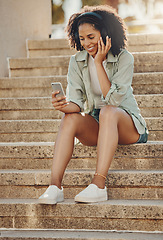 Image showing Black woman outdoor, phone and headphone for music, travel and 5g network for audio streaming in city. Happy person in Miami, listen to radio or podcast, relax on steps with internet and urban