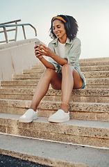Image showing Black woman outdoor, smartphone and headphones for music, travel and 5g network for audio streaming in city. Happy person in Miami, listen to radio or podcast, relax on steps with internet and urban