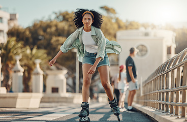 Image showing City, exercise and black woman roller skating for fitness, health and wellness outdoors. Sports practice, training and portrait of young female skater exercising, recreation or workout in street.