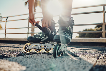 Image showing Fitness, hands and tie roller skates in city to start workout, health and wellness exercise. Sports practice, training and black woman skater tying shoes in street to get ready for skating outdoors.