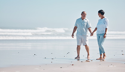 Image showing Senior couple walking on beach for love, care and relax on summer holiday, holding hands with mockup. Happy retirement, man and woman walk at sea for happiness and date with partner at calm ocean