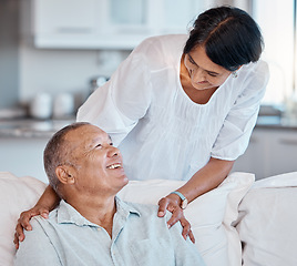 Image showing Love, retirement and relax with a senior couple in the living room of their home together for bonding. Sofa, happy smile or marriage with a mature man and woman relaxing in the lounge of their house