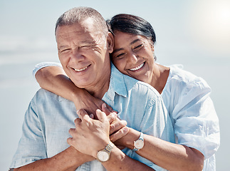 Image showing Senior couple, beach and hug of love, relax and trust on summer holiday, vacation or date. Happy retirement, man and woman embrace at ocean for happiness, support and smile outdoor in calm sunshine