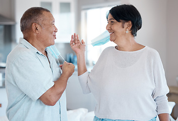 Image showing Covid, remove home mask and senior couple together talking with a smile in a kitchen. Happy man, mature and marriage of a grandparents in house laughing with happiness after end of virus quarantine