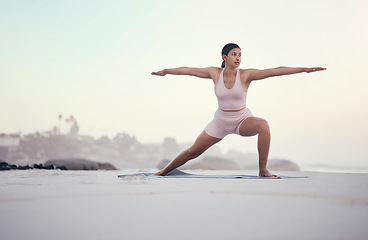 Image showing Yoga, warrior pose and woman on the beach doing a meditation for zen in nature. Sea, sand and young person with mindfulness workout outdoor to calm and relax chakra energy with pilates by ocean