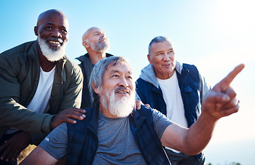 Image showing Senior hiking, blue sky and nature walk of elderly men together in retirement pointing. Friends, trekking adventure and happiness of old people outdoor for health, wellness and fitness on a journey