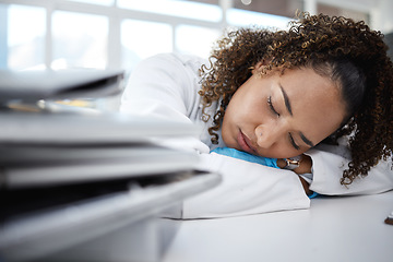 Image showing Science, tired and scientist sleeping in lab after working on innovation experiment, test or research. Exhausted, burnout and professional female scientific employee taking nap on desk in laboratory.