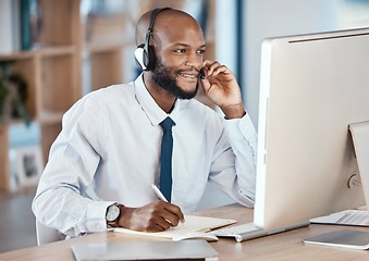 Image showing Call center, customer service and man consultant writing notes while doing a consultation online. Contact us, operator and African male telemarketing agent on computer planning crm strategy in office