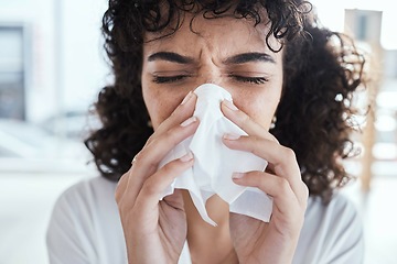 Image showing Black woman, tissue and nose with flu in home with self care, health and sneeze by blurred background. Gen z girl, toilet paper and sick with allergy, covid and closeup in house, apartment or room