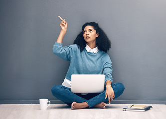 Image showing Laptop, thinking and pointing with black woman on floor with mockup for social media, news and presentation. Offer, online shopping and technology with girl for communication, internet or advertising