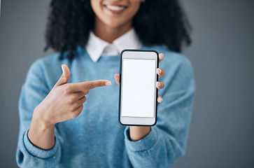 Image showing Mockup screen, phone or black woman pointing hand at digital marketing, branding or advertising content. Startup, web or girl in studio with smartphone for product space, internet or social media