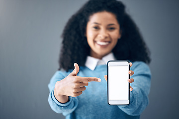 Image showing Mockup, phone screen or black woman pointing hand at digital marketing, branding or advertising content. Startup, web or girl in studio with smartphone for product space, internet or social media